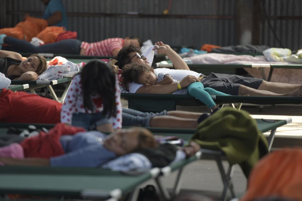 DEMING, N.M. – A father and his daughter nap together in the Deming migrant shelter Sunday, June 30, 2019.