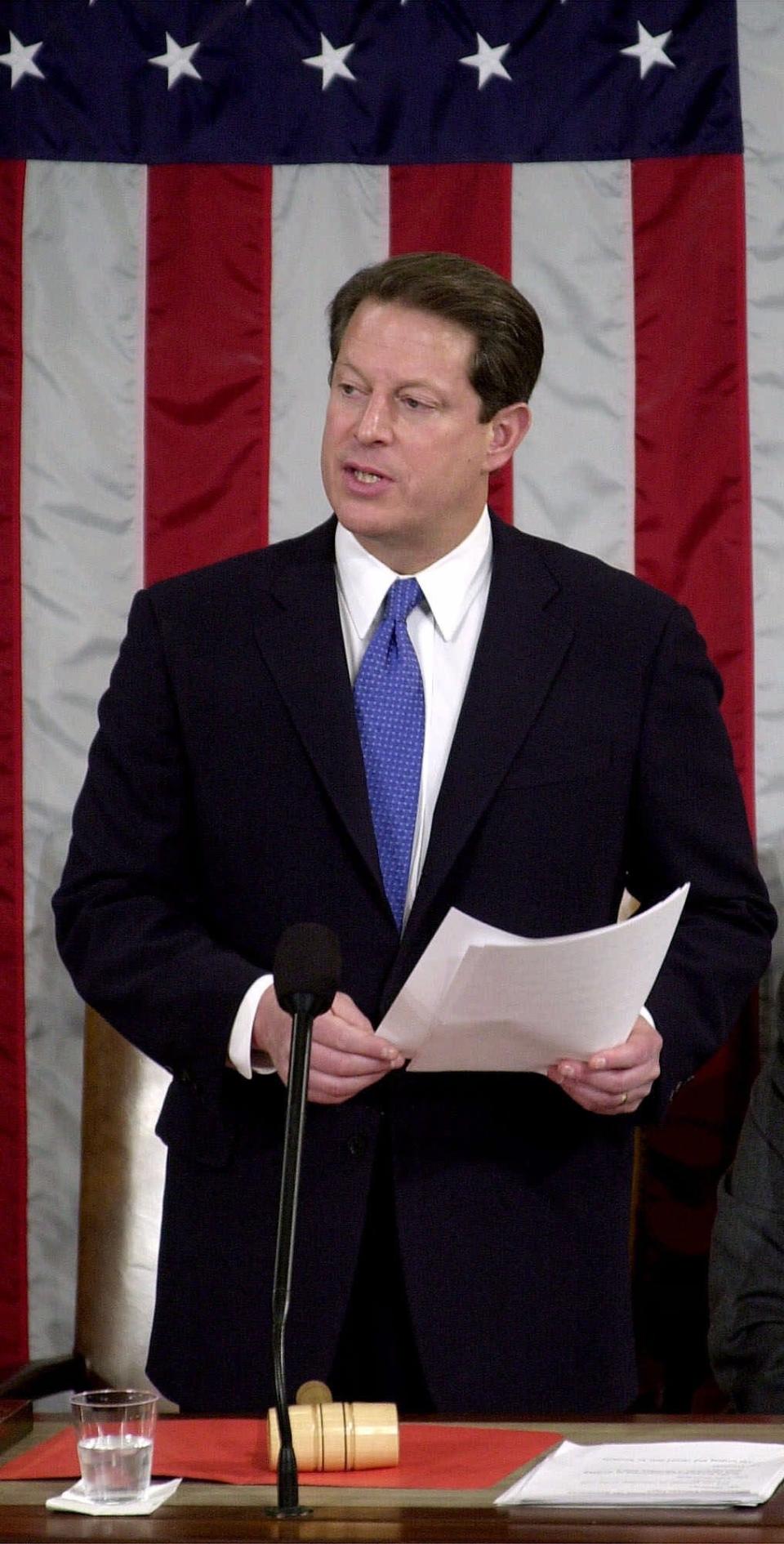 On Capitol Hill, Vice President Al Gore, who lost his bid for president, reads the final results of the electoral vote on the floor of the U.S. House of Representatives, during a joint session of Congress in Washington, Saturday, Jan. 6, 2001.