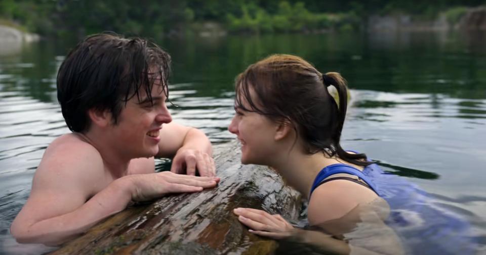 Ferdia Walsh-Peelo and Emilia Jones smiling in the water.