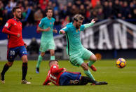 Football Soccer - Osasuna v Barcelona - Spanish La Liga Santander - El Sadar, Pamplona, Spain - 10/12/2016 Barcelona's Lionel Messi fights for the ball with Osasuna's Alex Berenguer. REUTERS/Vincent West