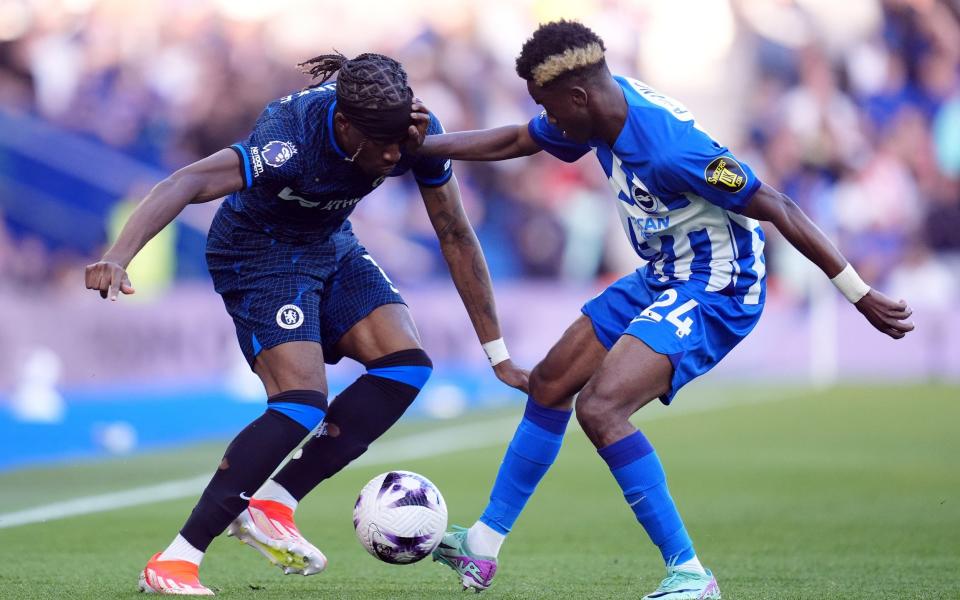 Chelsea's Noni Madueke and Brighton and Hove Albion's Simon Adingra (right) battle for the ball during the Premier League match at the Amex Stadium, Brighton and Hove