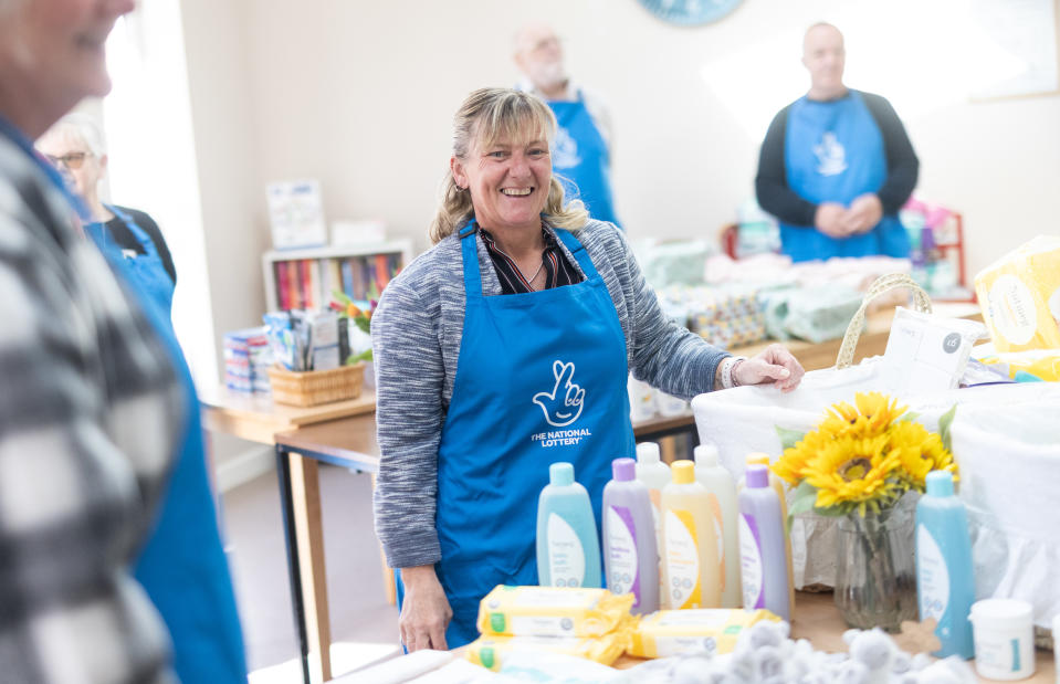 Kerry Swatman with a 'welcome to the world' kit that the lottery winners have been helping to pack. (National Lottery/ PA)