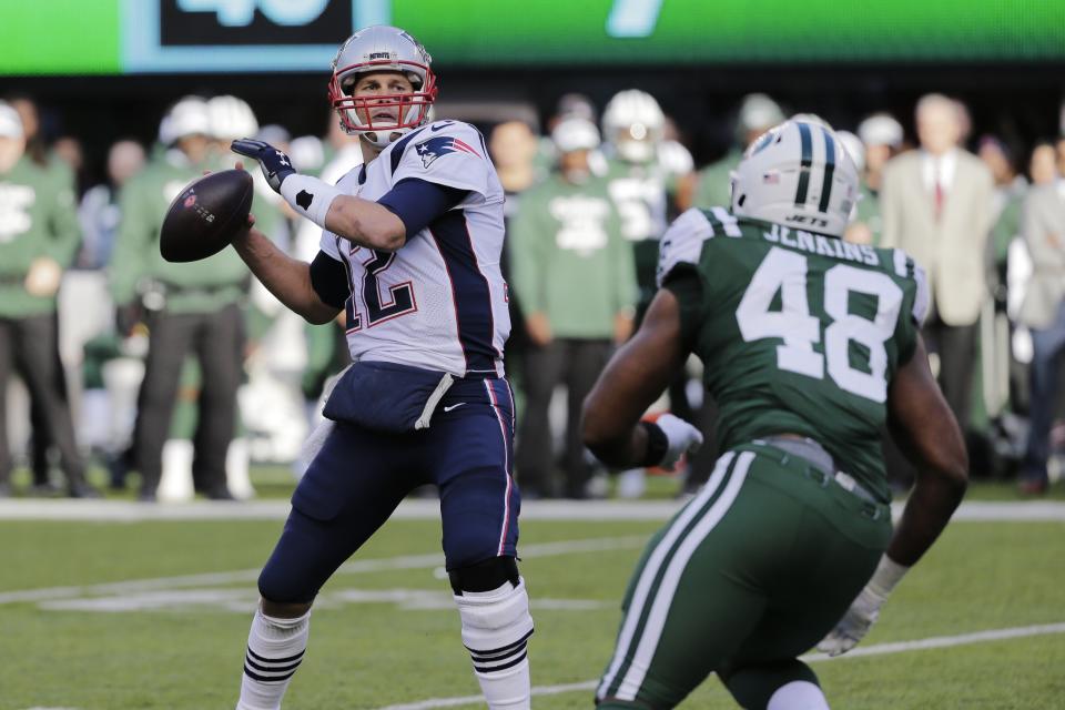 New England Patriots' Tom Brady (12) throws a pass over New York Jets' Jordan Jenkins (48) during the first half of an NFL football game Sunday, Nov. 25, 2018, in East Rutherford, N.J. (AP Photo/Seth Wenig)