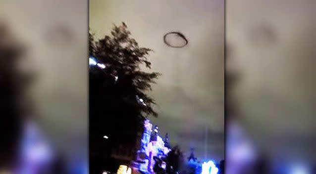 A black ring-shaped ‘UFO’ floating above the skies at Disneyland, California, terrified some park visitors. Picture: YouTube/Kyle Hawkins