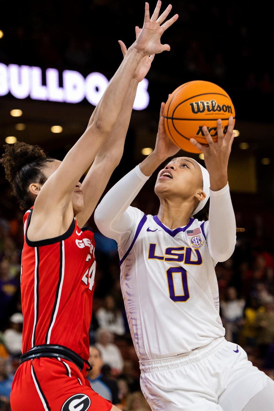 LSU's LaDazhia Williams (0) goes up to shoot over Georgia's Brittney Smith, left, in the first half of an NCAA college basketball game during the Southeastern Conference women's tournament in Greenville, S.C., Friday, March 3, 2023. (AP Photo/Mic Smith)