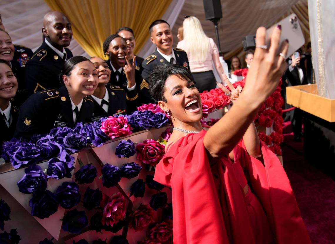 Ariana DeBose takes a photograph with members of the military at the Oscars on Sunday, March 27, 2022, at the Dolby Theatre in Los Angeles. John Locher/John Locher/Invision/AP