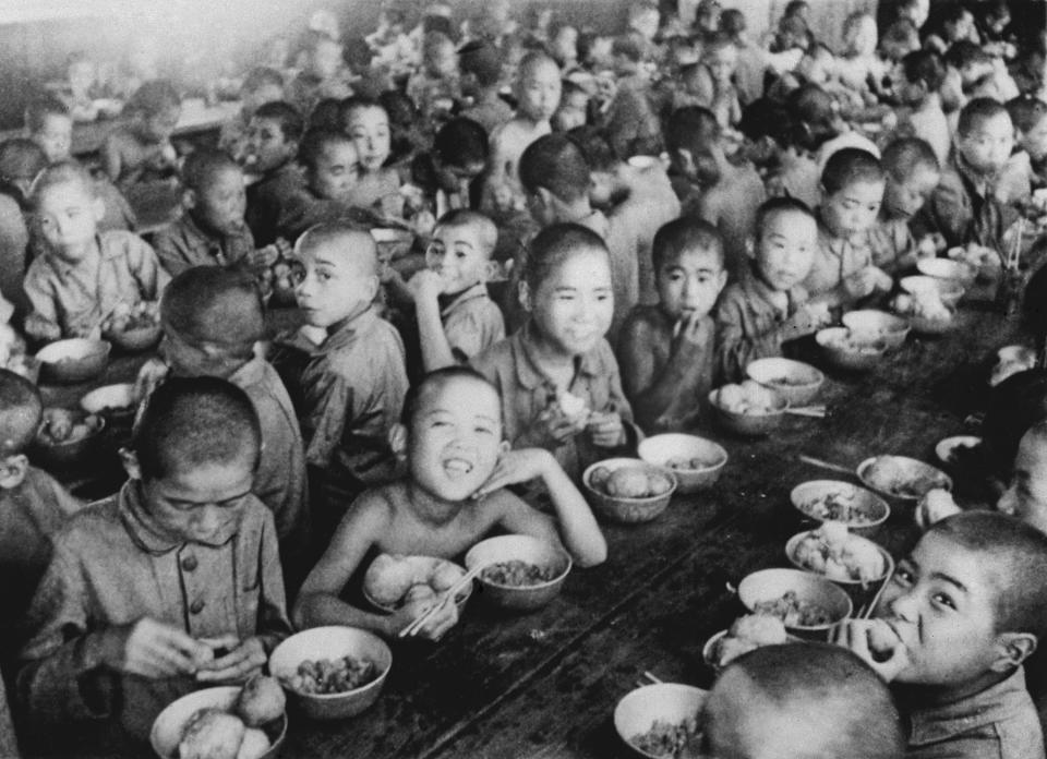 War orphans eat together at an orphanage in Tokyo in 1946. In Japan, war orphans were punished for surviving. They were bullied. They were called trash, sometimes rounded up by police and put in cages. Some were sent to institutions or sold for labor. They were targets of abuse and discrimination. A 1948 government survey found there were more than 123,500 war orphans nationwide. But orphanages were built for only for 12,000, leaving many homeless. (Kyodo News via AP)