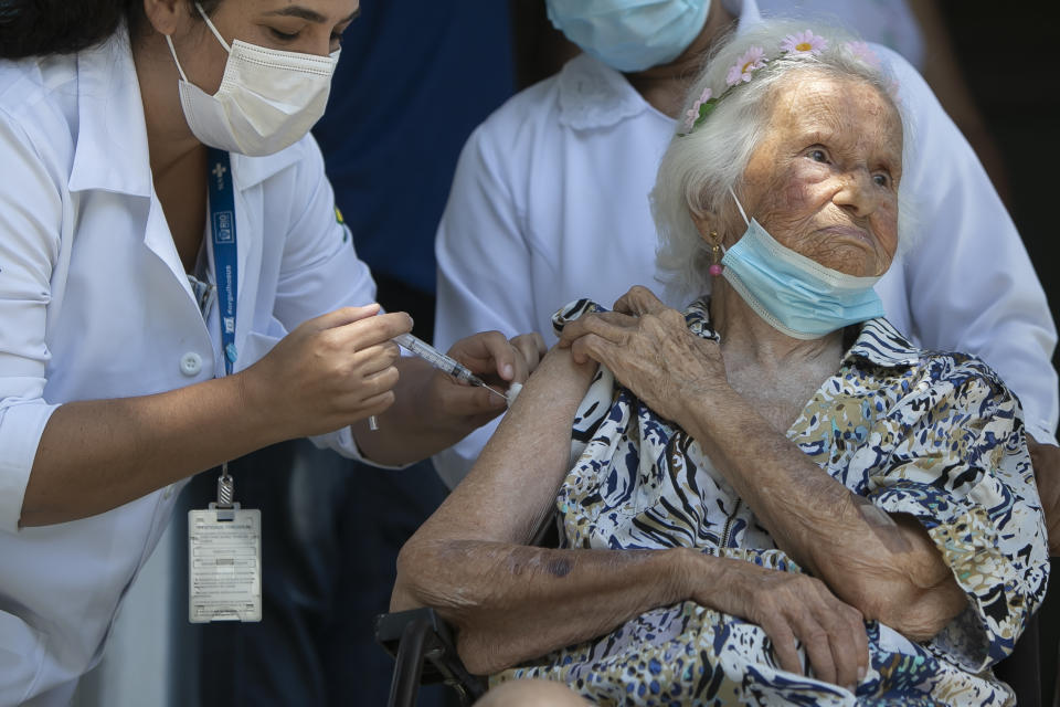 Zelia de Carvalho Morley, 106, gets a shot of China's Sinovac CoronaVac vaccine for the new coronavirus at the retirement home where she lives in Rio de Janeiro, Brazil, Wednesday, Jan. 20, 2021. De Carvalho Morley lived through the 1918 flu pandemic. (AP Photo/Bruna Prado)