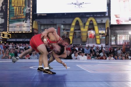 U.S. wrestler Zain Retherford (R) spars with Japanese wrestler Daichi Takatani at the "Beat The Streets" wrestling event in Times Square, New York City, U.S., May 17, 2017. REUTERS/Joe Penney