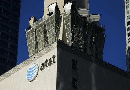 An AT&T logo and communication equipment is shown on a building in downtown Los Angeles, California October 29, 2014. REUTERS/Mike Blake