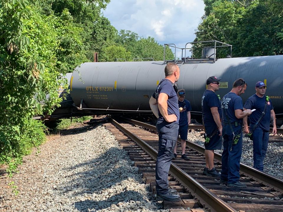 Emergency responders inspect a tanker that was among 33  Norfolk Southern train cars that derailed in Newberry Township near Goldsboro, Pa.