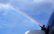 <p>A rainbow appears as Obama waves to nearby well-wishers.</p>
