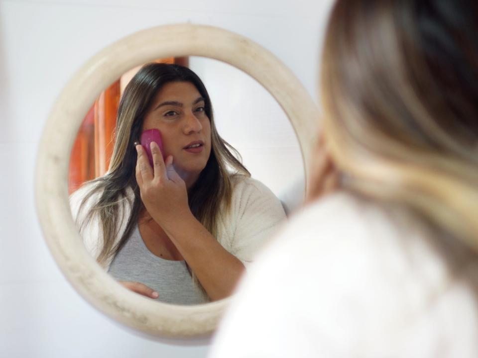 trans woman washing face