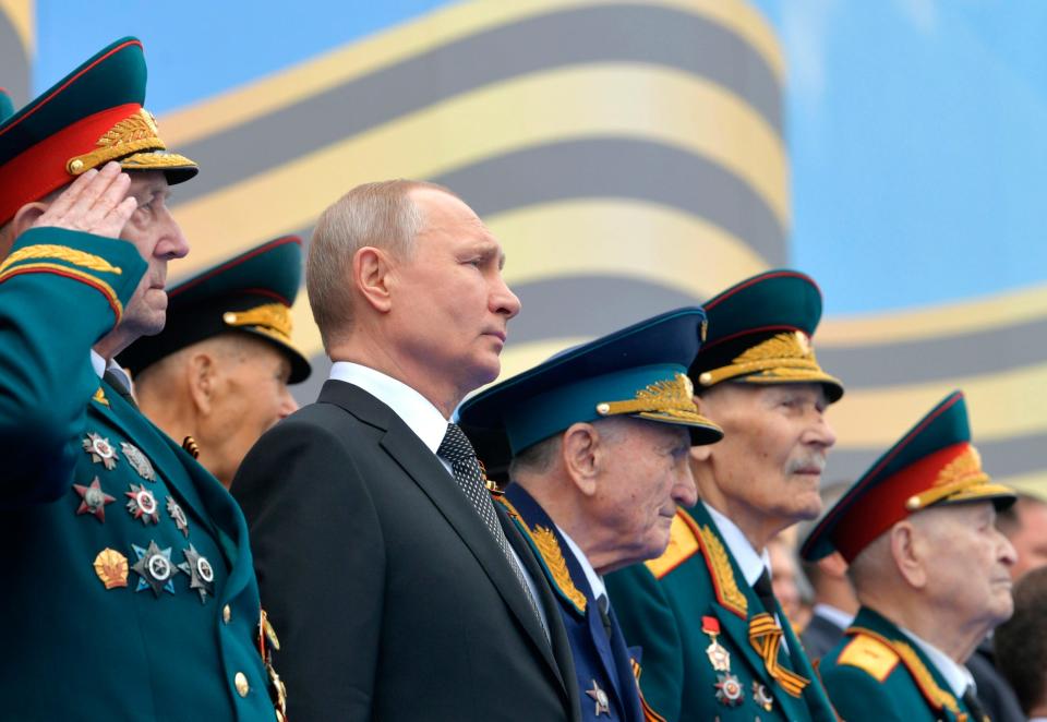 Surrounded by WWII veterans Russian President Vladimir Putin watches the military parade marking 74 years since the victory in WWII in Red Square in Moscow, Russia, Thursday, May 9, 2019.