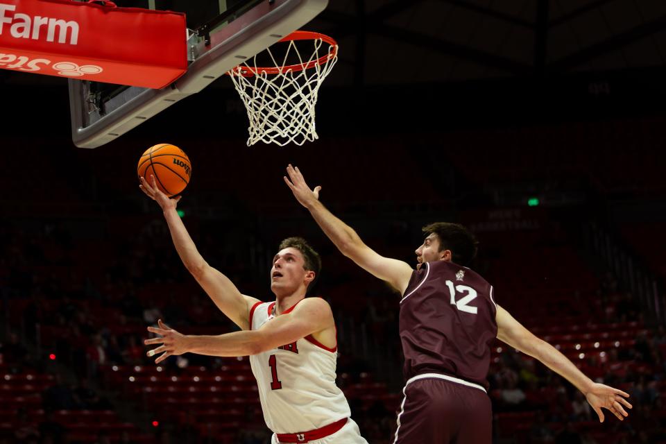 Utah Utes forward Ben Carlson (1) shoots the ball with Bellarmine Knights forward Langdon Hatton (12) on defense during the men’s college basketball game between the University of Utah and Bellarmine University at the Jon M. Huntsman Center in Salt Lake City on Wednesday, Dec. 20, 2023.