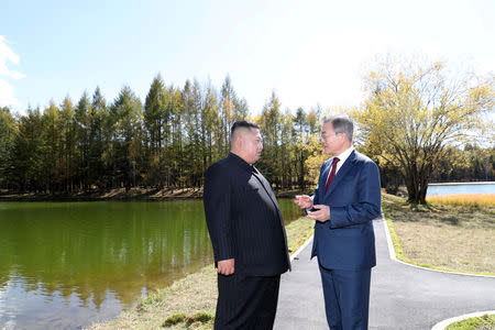 FILE PHOTO: North Korean leader Kim Jong Un and South Korean President Moon Jae-in talk while taking a walk at Samjiyon Guesthouse in Ryanggang province, North Korea, September 20, 2018. Pyeongyang Press Corps/Pool via REUTERS