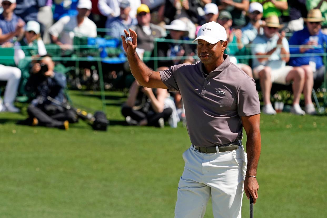 Tiger Woods reacts to his putt on the 18th green after making his 24th consecutive cut at The Masters to set an all-time record.