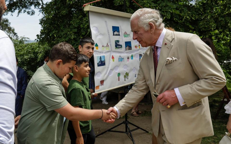 The King pictured on Tuesday during his private trip to Romania. Here, he meets groups that have benefited from support from The Prince's Foundation - Octav Ganea