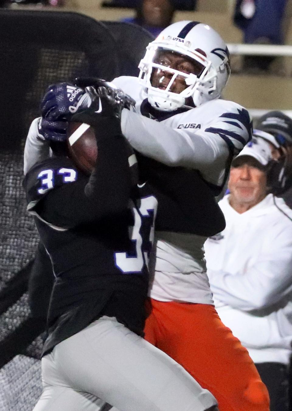 MTSU cornerback Decorian Patterson (33) intercepts the ball intended UTSA wide receiver Zakhari Franklin (4) for on Friday, Sept. 30, 2022, in Floyd Stadium at MTSU.