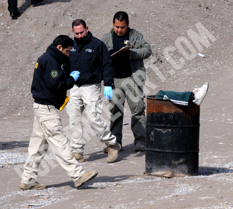 This undated file photo shoes police investigators following the discovery of a body in a barrel in Juarez, Mexico. (Courtesy Lucio Soria)