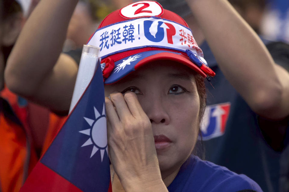 A supporter of Nationalist or KMT party candidate Han Kuo-yu watches election returns in Kaohsiung, Taiwan, Saturday, Jan. 11, 2020. Unofficial early results from Taiwanese television networks showed President Tsai Ing-wen leading her closest challenger, Han of the Nationalist Party, in Saturday's presidential election, possibly putting her on the way to winning a second term. (AP Photo/Ng Han Guan)
