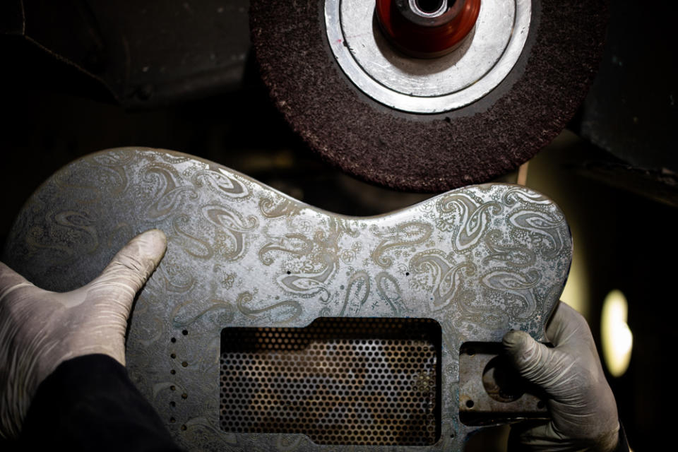 After being screen printed, dried and sprayed with the fixer, the guitar body gets polished at James Trussart's workshop in East Los Angeles.