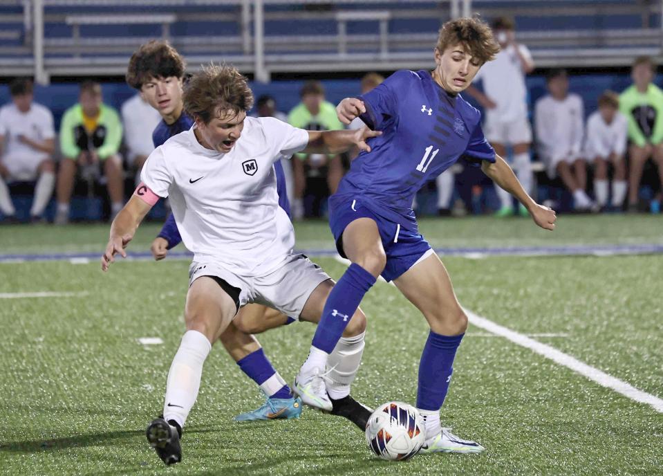 Moeller's Charlie Niehaus (17) battles St. Xavier's Teddy Mueller (11) during their soccer game Tuesday, Oct. 4. The Crusaders face Centerville in a Division I regional semifinal. Both teams have just one loss.