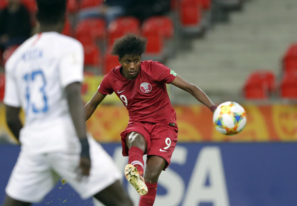 FILE - Qatar's Yusuf Abdurisag kicks the ball during the Group D U20 World Cup soccer match between USA and Qatar, in Tychy, Poland, Thursday, May 30, 2019. Qatar soccer player Yusuf Abdurisag was accused on Monday, June 19, 2023, by the New Zealand team of racially abusing one of its players who is of Samoan heritage during an international friendly game in Austria. A series of incidents involving racial and homophobic abuse at international games in the past week is evidence of “the urgent crisis” soccer is facing, anti-discrimination group Fare said Tuesday, June 20, 2023. It comes just days after FIFA president Gianni Infantino said games must be stopped to deal with the problem of racism. (AP Photo/Sergei Grits, File)