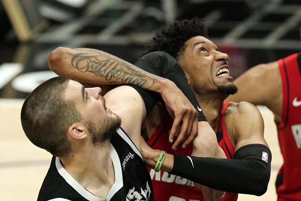 Los Angeles Clippers center Ivica Zubac, left, and Houston Rockets center Christian Wood battle for a rebound during the second half of an NBA basketball game Friday, April 9, 2021, in Los Angeles. The Clippers won 126-109. (AP Photo/Mark J. Terrill)
