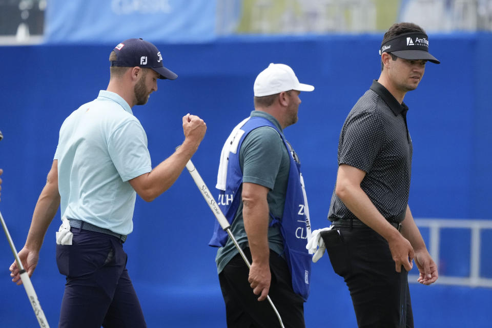 Wyndham Clark, left, and his teammate Beau Hossler, right, walk off the 9th green after finishing for the day during the second round of the PGA Zurich Classic golf tournament at TPC Louisiana in Avondale, La., Friday, April 21, 2023. (AP Photo/Gerald Herbert)