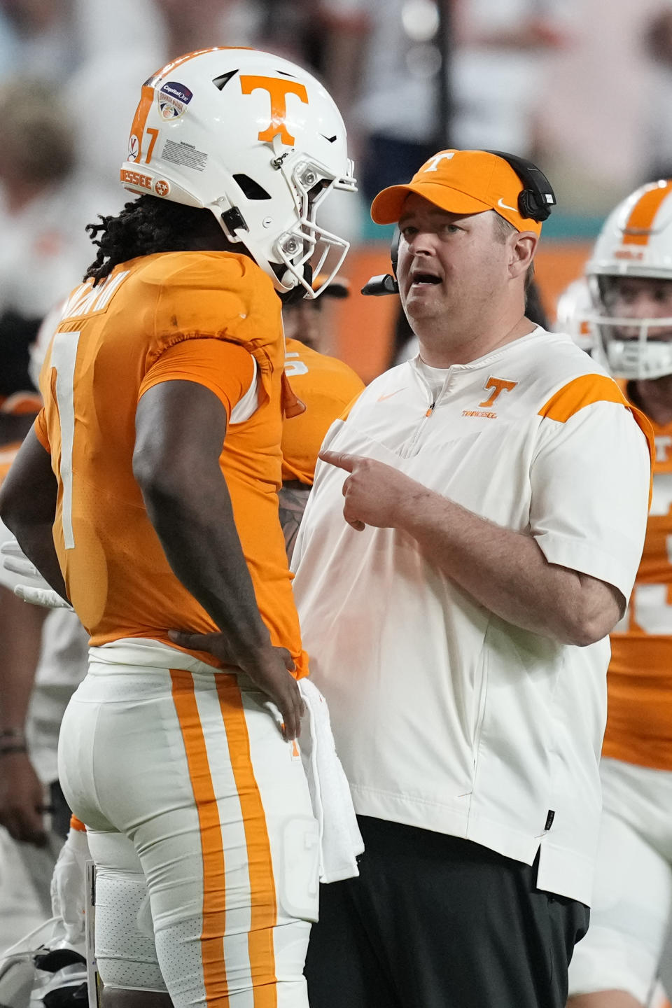 Tennessee head coach Josh Heupel, front right, talks with quarterback Joe Milton III (7) during the first half of the Orange Bowl NCAA college football game against Clemson, Friday, Dec. 30, 2022, in Miami Gardens, Fla. (AP Photo/Rebecca Blackwell)