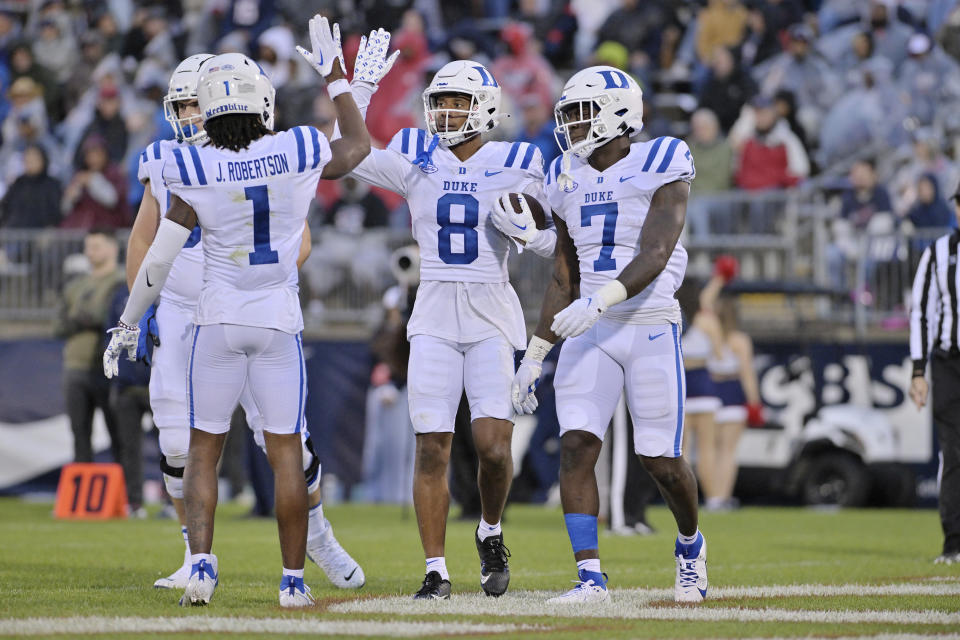 Duke wide receiver Jordan Moore (8) is congratulated by wide receiver Jontavis Robertson (1) after a second-half touchdown against UConn during an NCAA college football game, Saturday, Sept. 23, 2023 in Hartford, Conn. (AP Photo/Josh Reynolds)