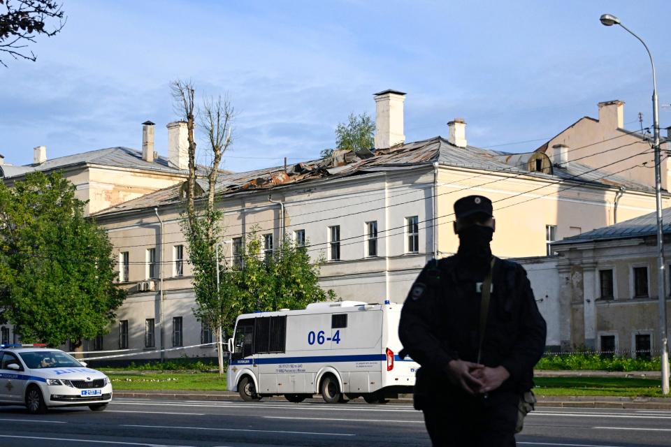 Police secures an area outside a damaged non-residential building on Komsomolsky Prospekt after a reported drone attack in Moscow on July 24, 2023.