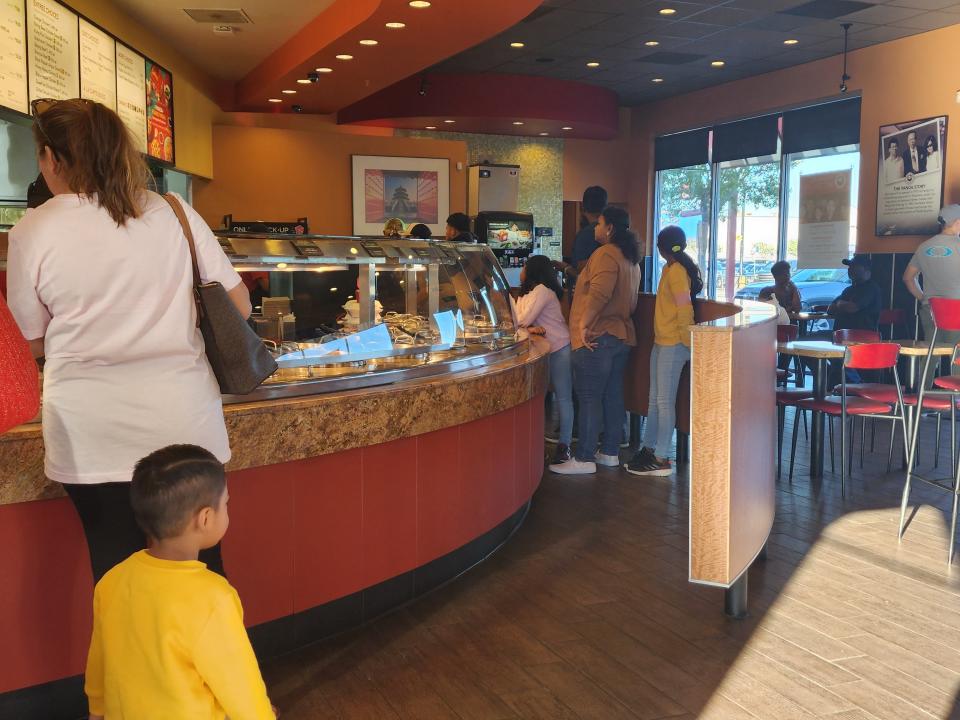 Interior of Panda Express with counter and customers ordering at counter