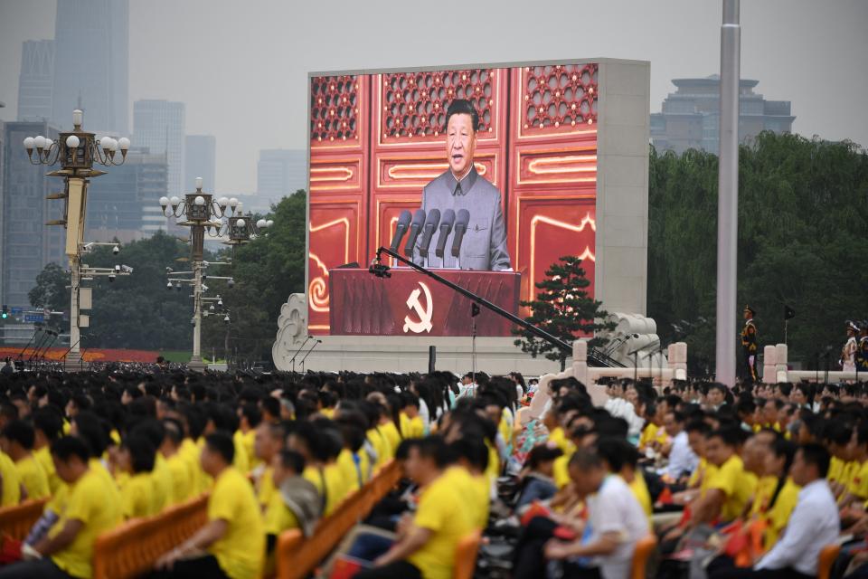 Chinese President Xi Jinping (on screen) delivers a speech during the celebrations of the 100th anniversary of the founding of the Communist Party of China at Tiananmen Square in Beijing on July 1, 2021. (Photo by WANG Zhao / AFP) (Photo by WANG ZHAO/AFP via Getty Images)
