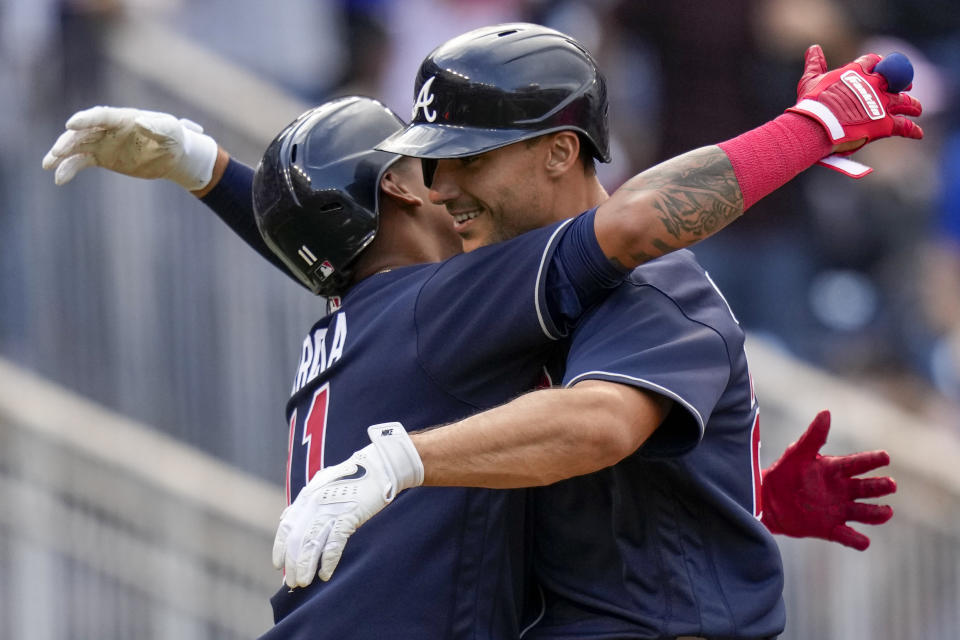 Atlanta Braves' Orlando Arcia, left, celebrates with Matt Olson after they scored on Olson's two-run home run during the seventh inning of a baseball game against the Washington Nationals at Nationals Park, Saturday, April 1, 2023, in Washington. (AP Photo/Alex Brandon)