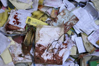 A view of the bloody books and supplies that left from Friday's suicide bomber attack on a Hazara education center, Kabul, Afghanistan, Saturday, Oct. 1, 2022. Afghanistan's Hazaras, who are mostly Shiite Muslims, have been the target of a brutal campaign of violence for the past several years. (AP Photo/Ebrahim Noroozi)