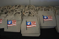 Reusable bags printed with a message advocating food freedom sit on a table at a pop-up tasting event for "lab-grown" meat produced by California-based Upside Foods, Thursday, June 27, 2024, in Miami. As Florida's ban on lab-grown meat is set to go into effect next week, one manufacturer hosted a tasting party, serving up cultivated chicken tostadas to dozens of attendees on a rooftop in Miami's Wynwood neighborhood. (AP Photo/Rebecca Blackwell)