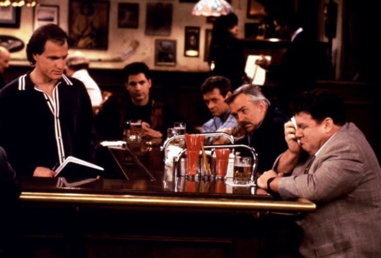 From left, Woody Harrelson, John Ratzenberger, and George Wendt in the <em>Cheers</em> series finale, “One for the Road,” 1993. (Photo: Everett Collection)