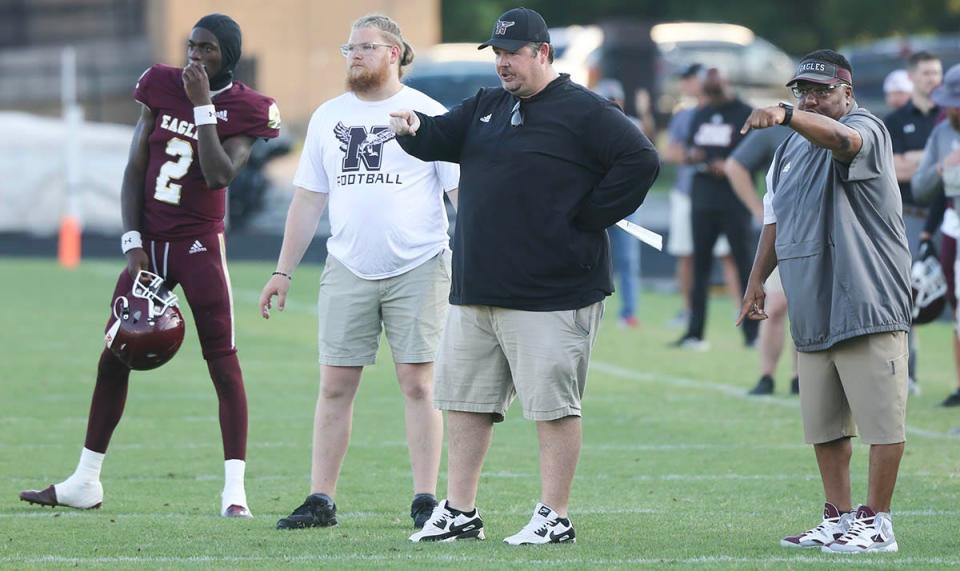 Head coach Grant Thompson,in black, makes play adjustments from the sideline during a Niceville Escambia spring football scrimmage at Niceville.