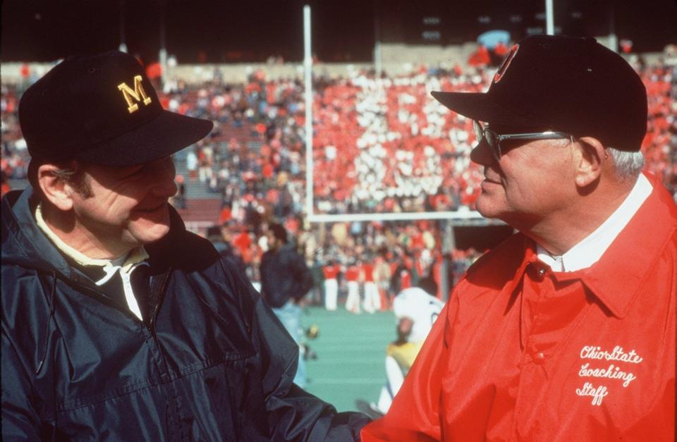 Coaches Bo Schembechler of Michigan and Woody Hayes of Ohio State meet before a game.