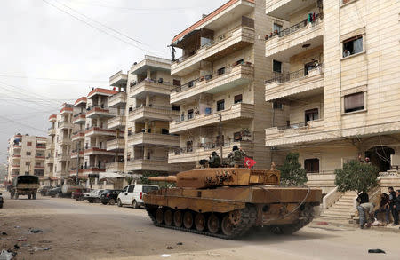 Turkish soldiers ride on a military vehicle in the center of Afrin, Syria March 24, 2018. REUTERS/Khalil Ashawi