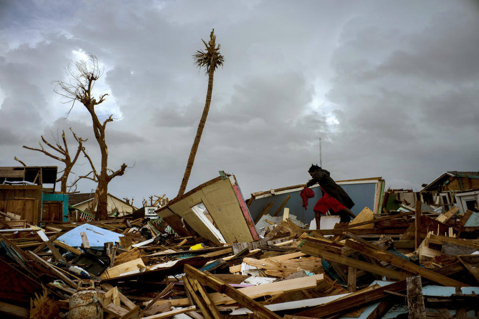 Vladimir Safford an immigrant from Haiti walks through the rubble next to his home in the aftermath of Hurricane Dorian in Abaco, Bahamas, Monday, Sept. 16, 2019. Dorian hit the northern Bahamas on Sept. 1, with sustained winds of 185 mph (295 kph), unleashing flooding that reached up to 25 feet (8 meters) in some areas. (AP Photo/Ramon Espinosa)