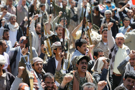 Armed people demonstrate outside the United Nations offices against Saudi-led air strikes on funeral hall in Sanaa, October 9, 2016. REUTERS/Khaled Abdullah