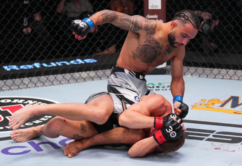 LAS VEGAS, NEVADA – AUGUST 12: Isaac Dulgarian punches Francis Marshall in a featherweight fight during the UFC Fight Night event at UFC APEX on August 12, 2023 in Las Vegas, Nevada. (Photo by Al Powers/Zuffa LLC via Getty Images)