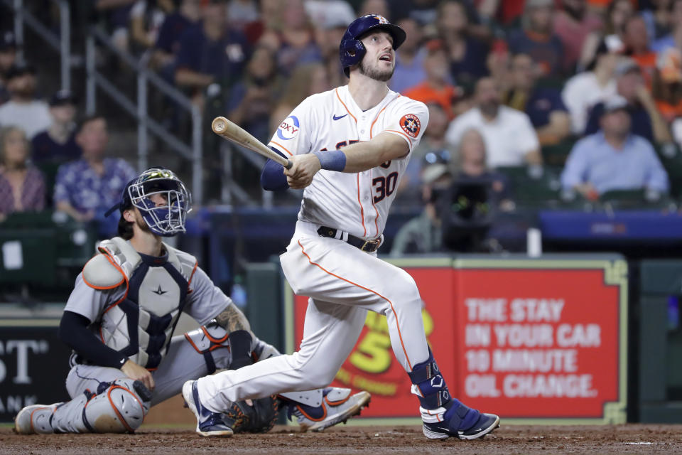 Houston Astros' Kyle Tucker (30) watches his home run in front of Detroit Tigers catcher Eric Haase, left, during the fourth inning of a baseball game Wednesday, April 5, 2023, in Houston. (AP Photo/Michael Wyke)