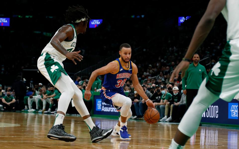 Warriors guard Stephen Curry drives on Celtics center Robert Williams III during first-quarter action on Friday.