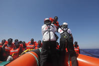 African migrants on a rubber boat in the Mediterranean Sea, off Libya are rescued by the MV Geo Barents vessel of MSF (Doctors Without Borders), in the central Mediterranean route, Monday, Sept. 20, 2021. (AP Photo/Ahmed Hatem)