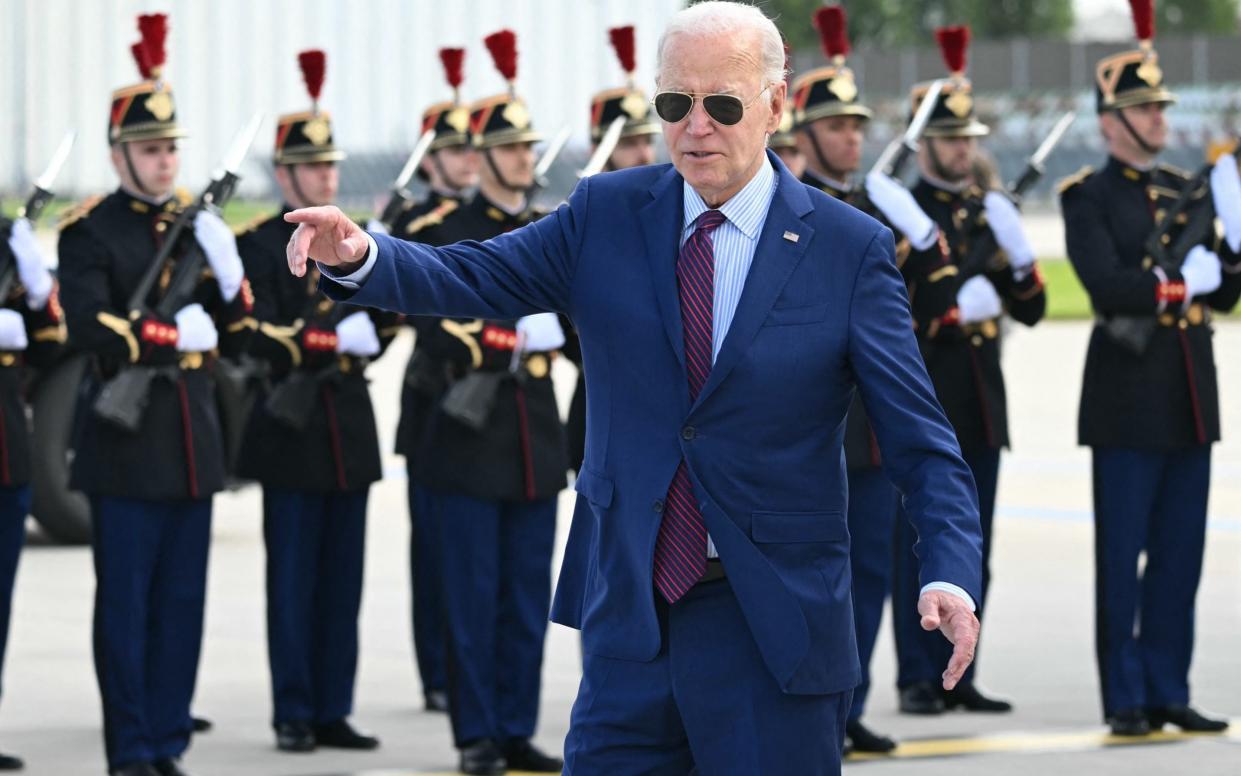 US President Joe Biden walks on the tarmac upon arrival in Paris