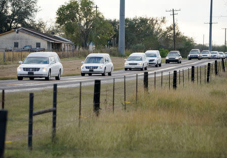 Hearses carry the bodies of six members of the Holcombe family and 3 members of the Hill family, victims of the Sutherland Springs Baptist church shooting, to a grave side service in Sutherland Springs, Texas, U.S. November 15, 2017. REUTERS/Darren Abate